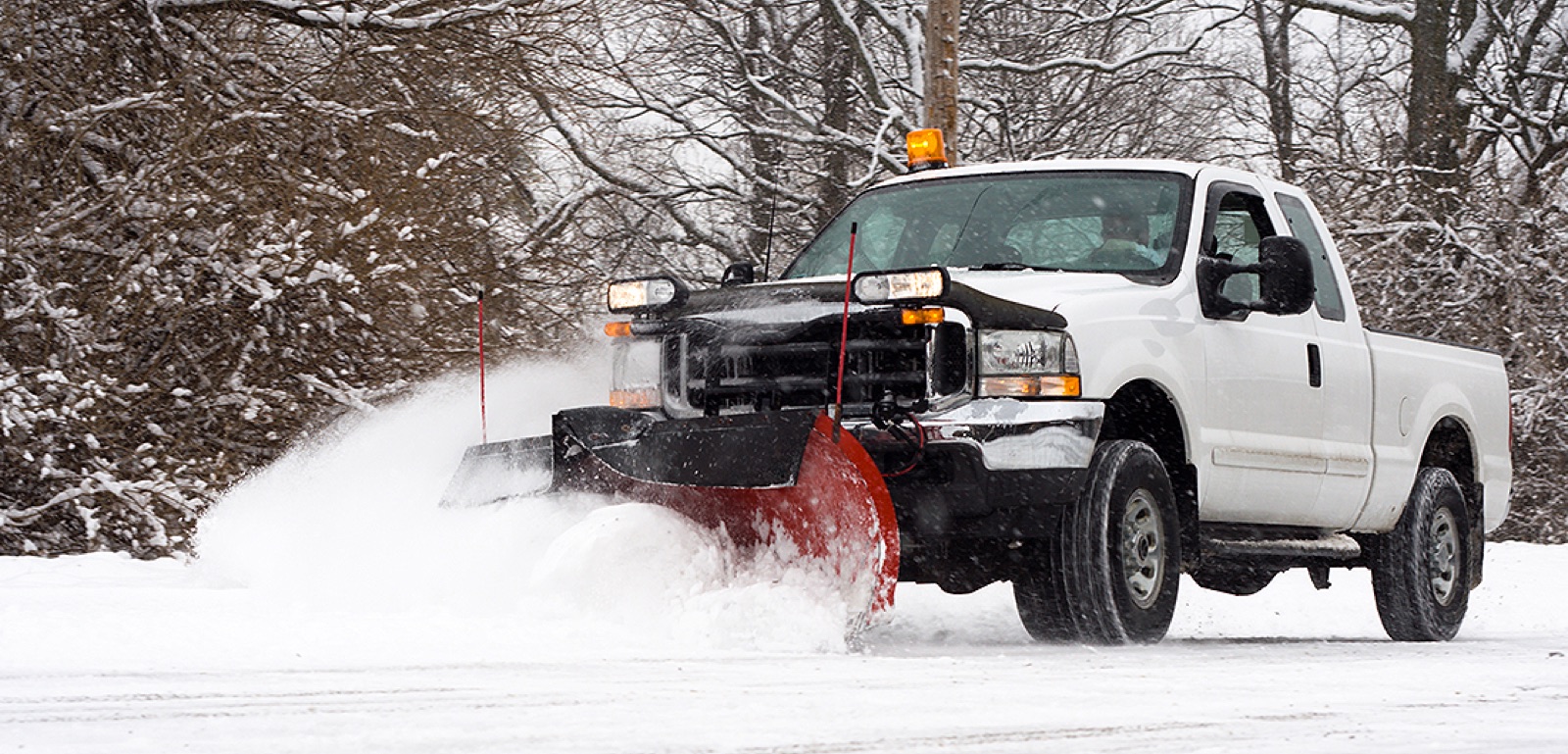 Large snow plow truck clearing snow